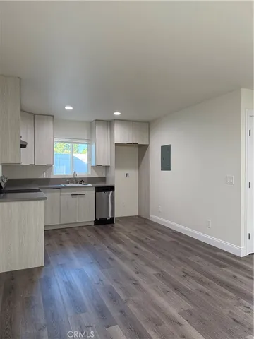 a kitchen with a wooden floor and window