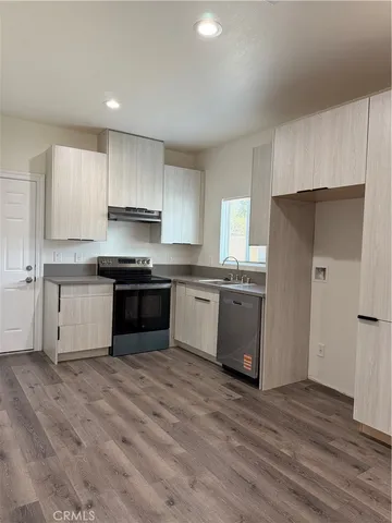 a kitchen with stainless steel appliances a refrigerator sink and cabinets
