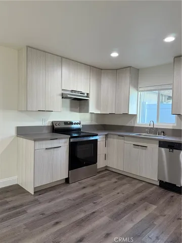 a kitchen with granite countertop wooden cabinets and stainless steel appliances