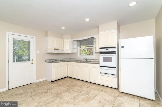 a kitchen with granite countertop cabinets appliances and a counter top space