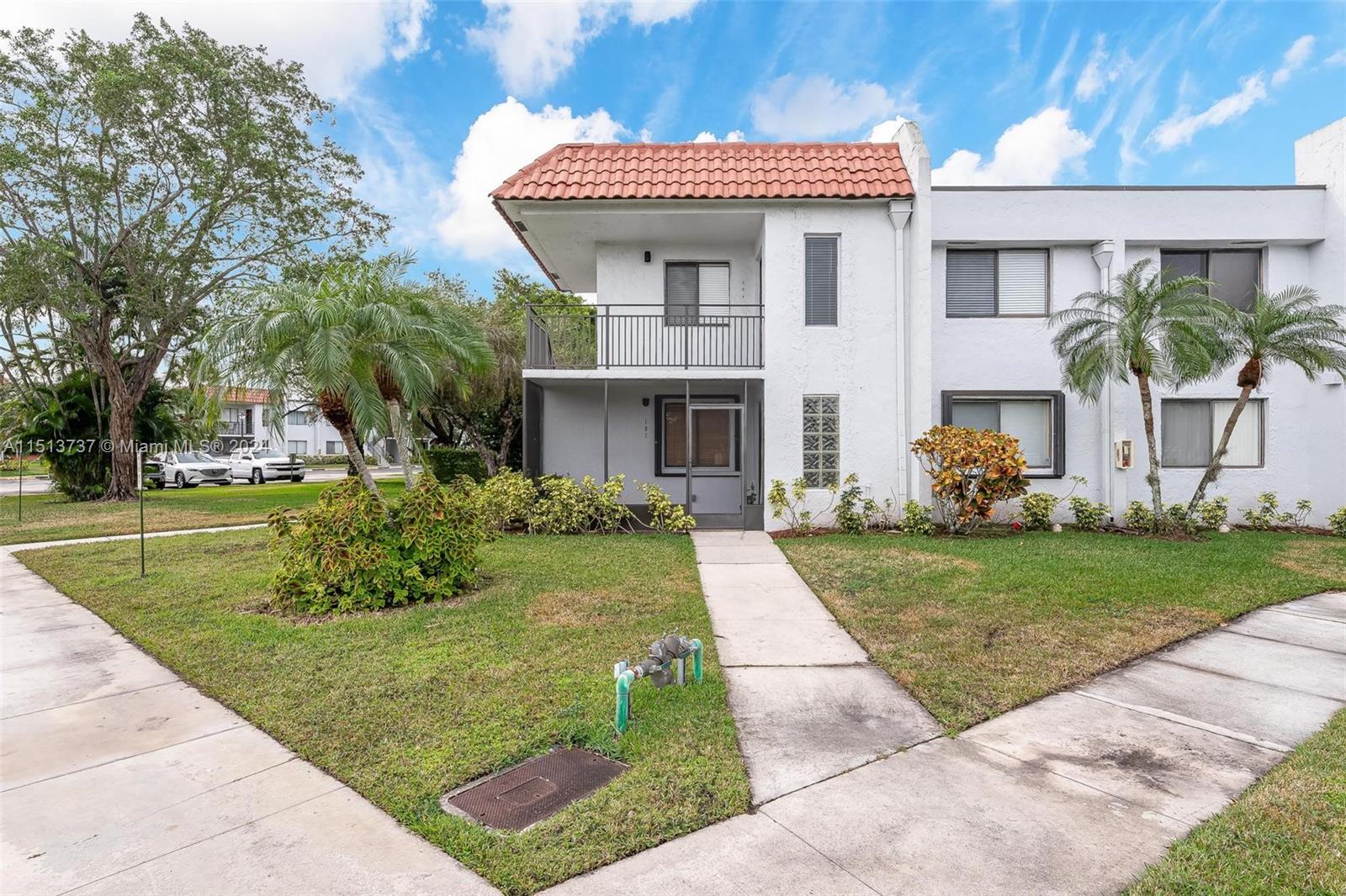 304 Racquet Club Road, Unit 101 Weston, FL 33326 - Photo 1 of 29 a front view of a house with garden
