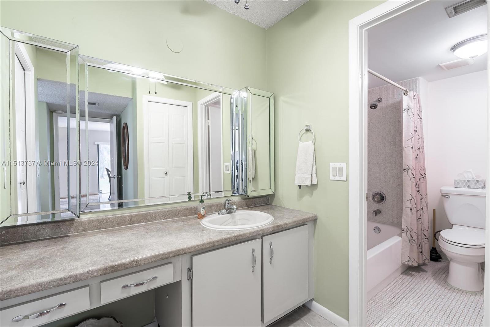 304 Racquet Club Road, Unit 101 Weston, FL 33326 - Photo 14 of 29 a bathroom with a sink a toilet and shower