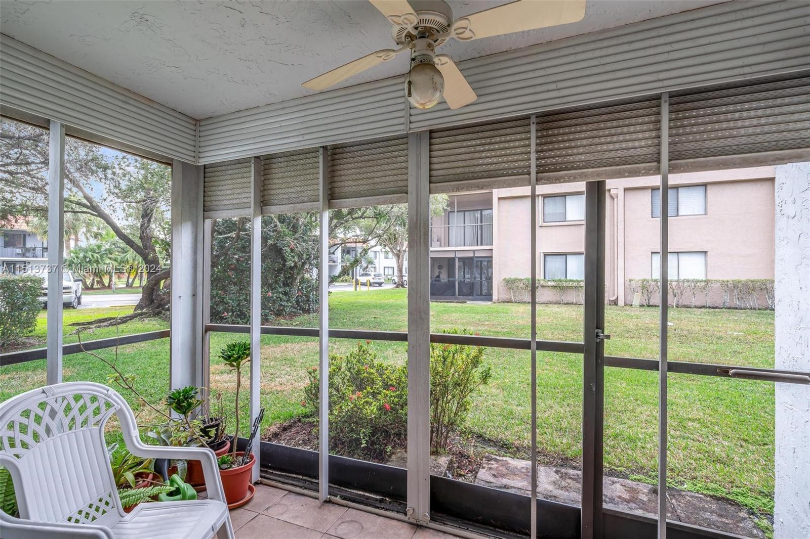 304 Racquet Club Road, Unit 101 Weston, FL 33326 - Photo 20 of 29 a view of a porch with furniture and garden