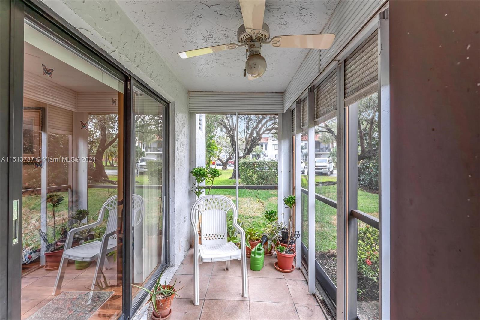 304 Racquet Club Road, Unit 101 Weston, FL 33326 - Photo 21 of 29 a living room filled with furniture and a potted plant