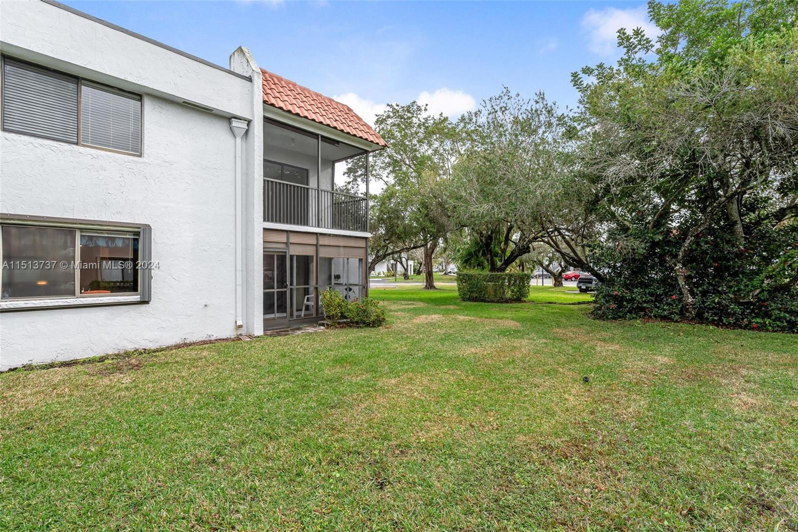 304 Racquet Club Road, Unit 101 Weston, FL 33326 - Photo 22 of 29 a view of a house with a yard and tree s