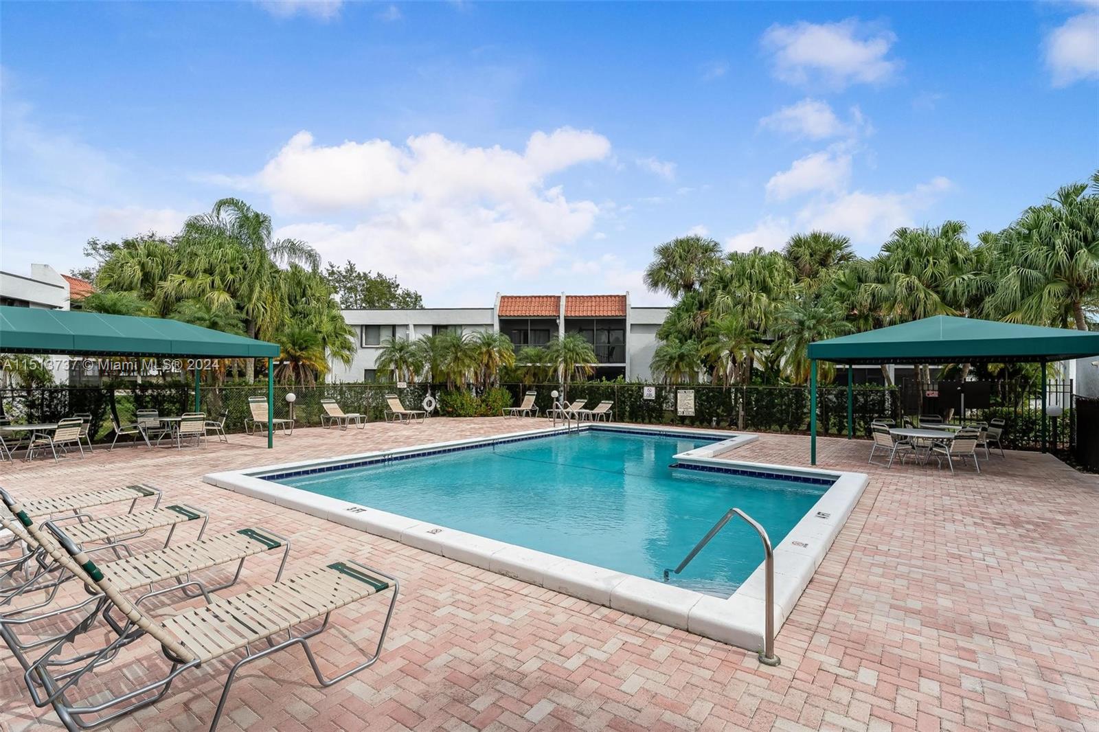 304 Racquet Club Road, Unit 101 Weston, FL 33326 - Photo 24 of 29 an outdoor space with swimming pool and furniture