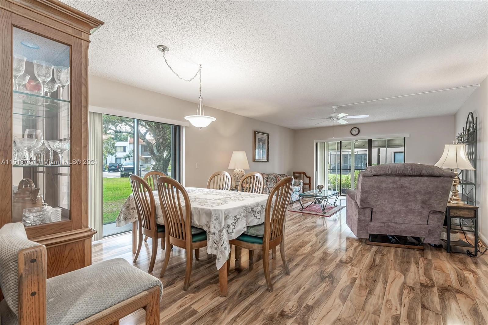 304 Racquet Club Road, Unit 101 Weston, FL 33326 - Photo 6 of 29 a view of a dining room with furniture window and wooden floor