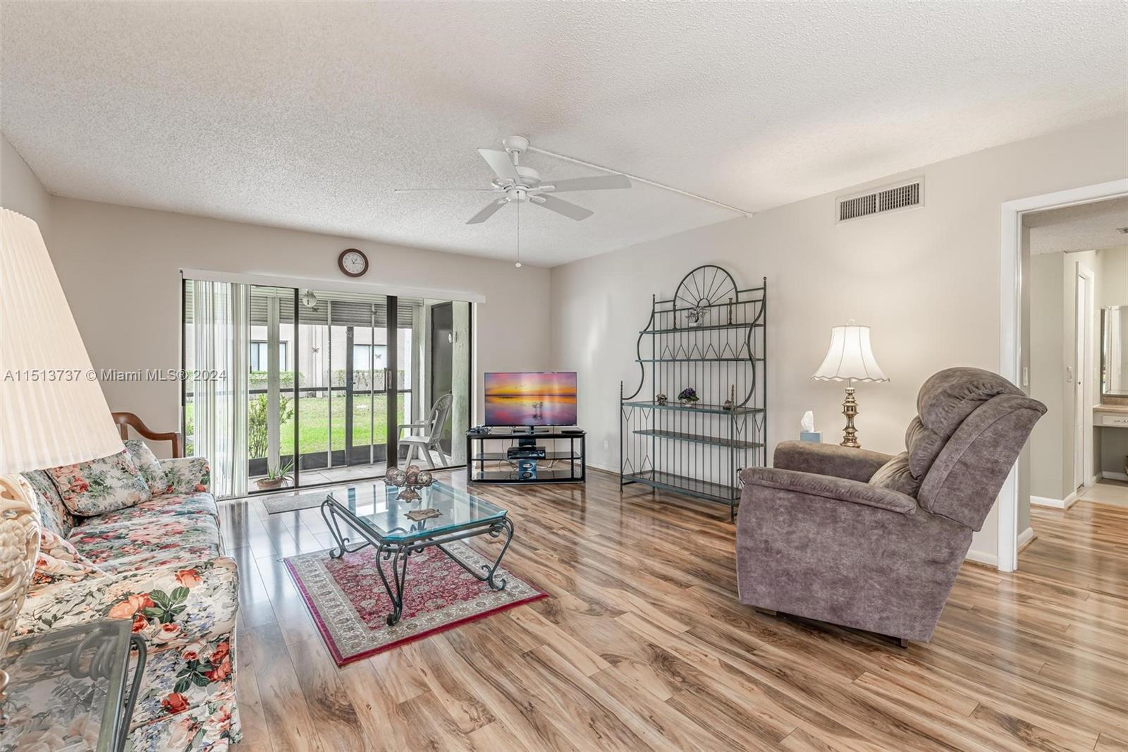 304 Racquet Club Road, Unit 101 Weston, FL 33326 - Photo 9 of 29 a living room with furniture and a window