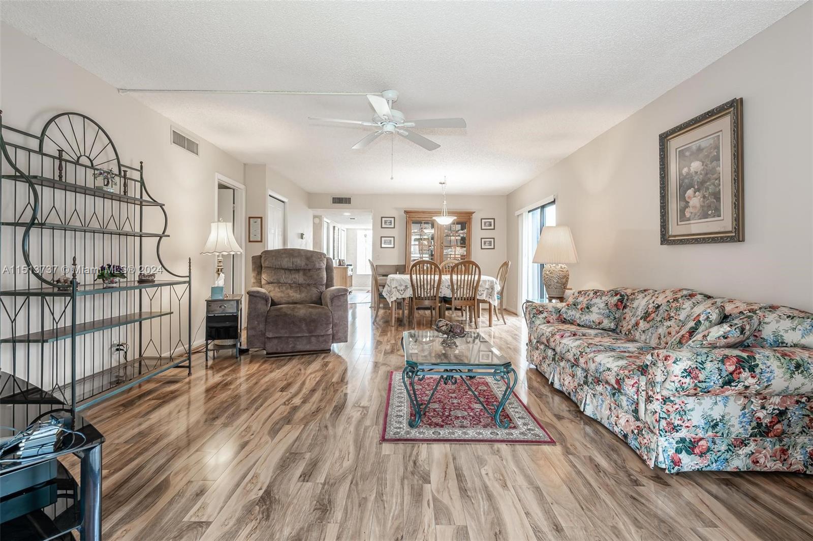 304 Racquet Club Road, Unit 101 Weston, FL 33326 - Photo 10 of 29 a living room with furniture and a wooden floor