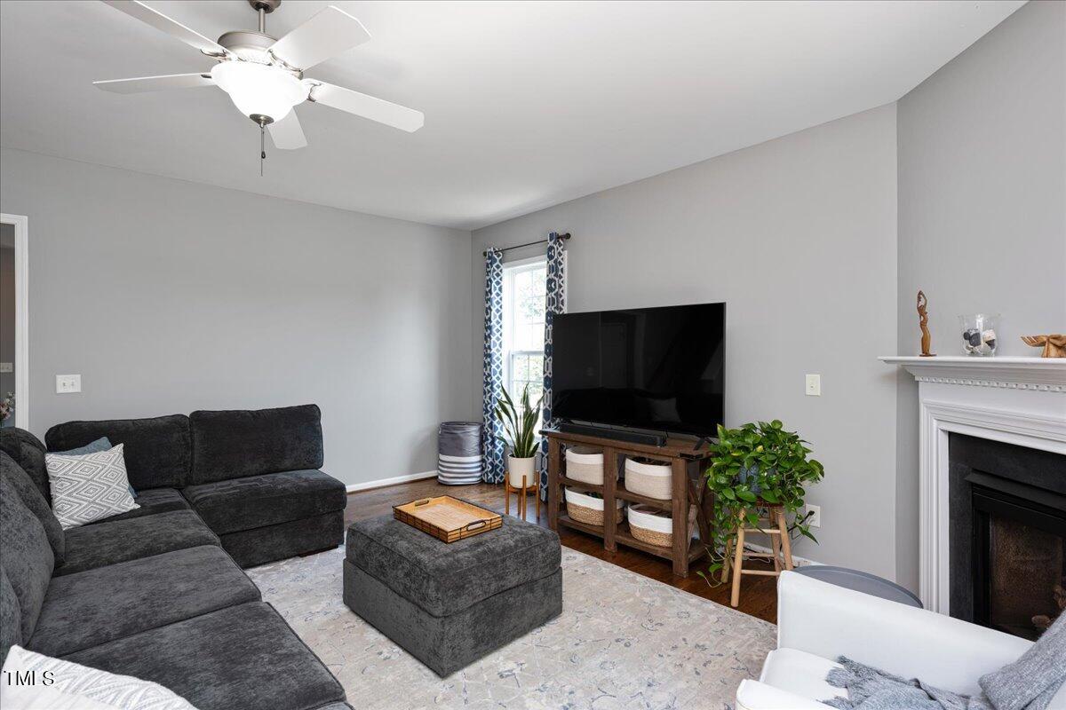 237 Mickleson Ridge Drive Raleigh, NC 27603 - Photo 11 of 42 a living room with furniture and a flat screen tv