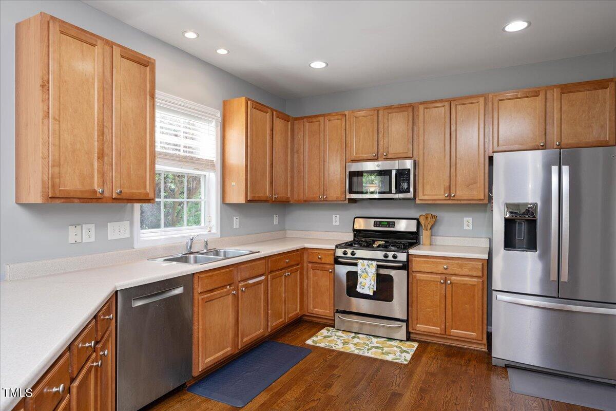 237 Mickleson Ridge Drive Raleigh, NC 27603 - Photo 13 of 42 a kitchen with a sink stainless steel appliances and window