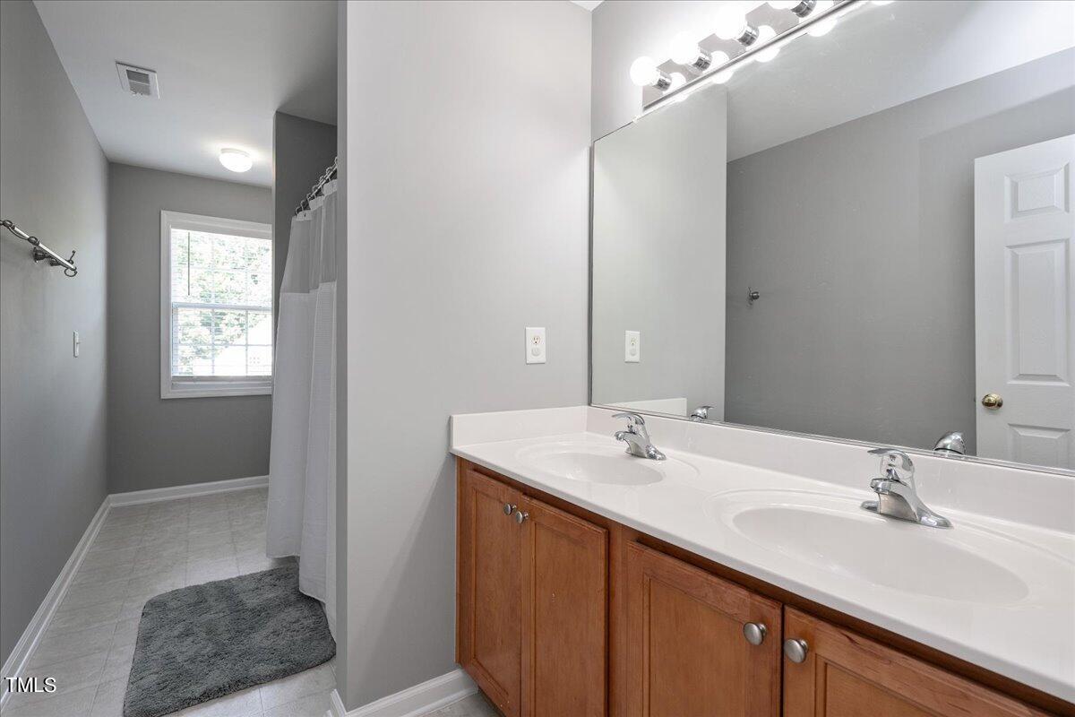 237 Mickleson Ridge Drive Raleigh, NC 27603 - Photo 25 of 42 a bathroom with a sink double vanity and a mirror