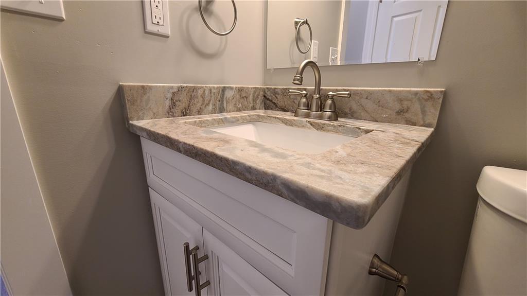 1331 Freeport Road Cheswick, PA 15024 - Photo 29 of 32 a bathroom with a granite countertop sink and a mirror