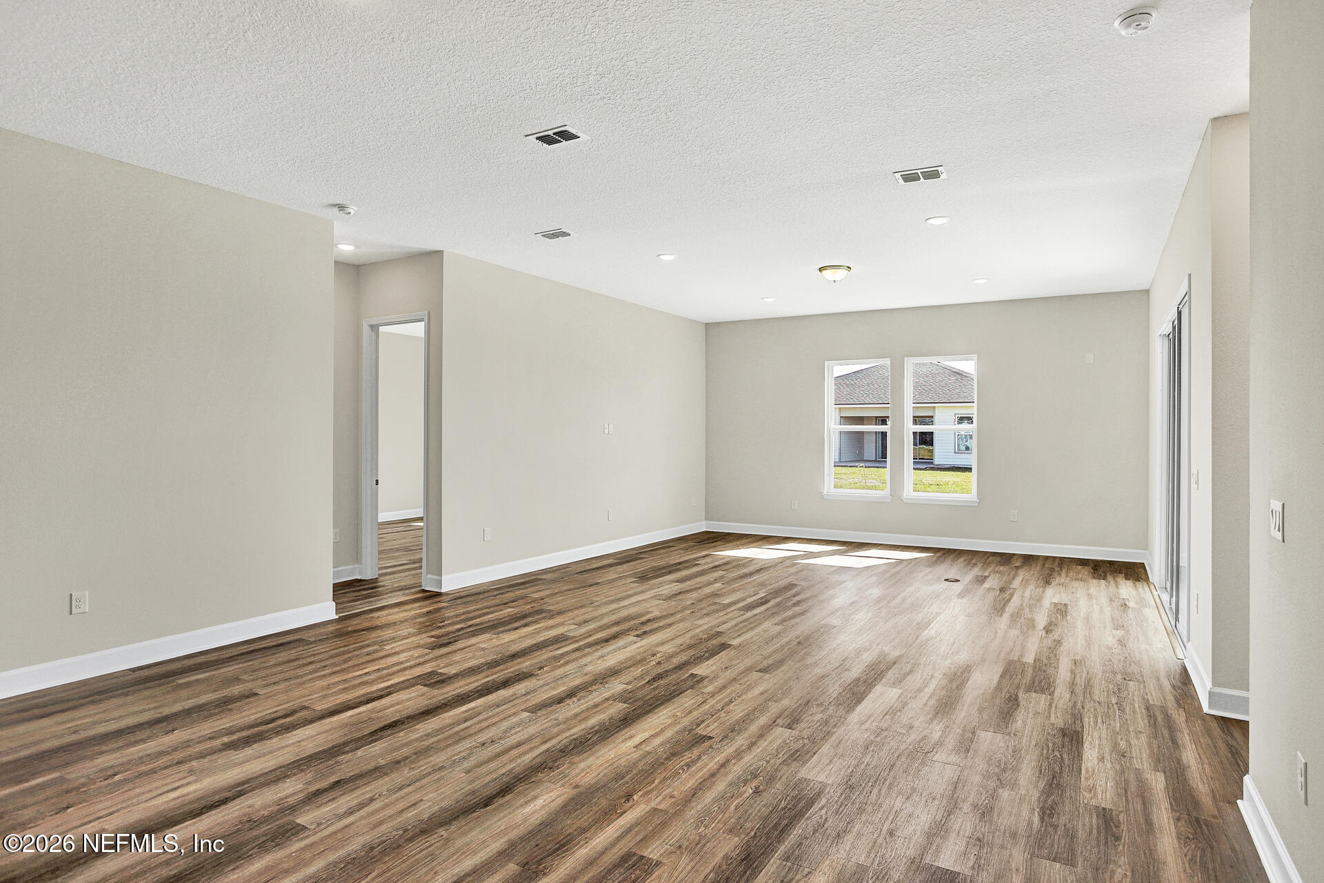 61 Ribera Drive Flagler Beach, FL 32136 - Photo 13 of 21 wooden floor in an empty room with a window