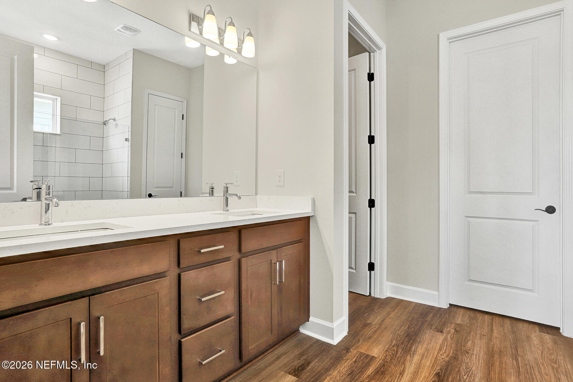 61 Ribera Drive Flagler Beach, FL 32136 - Photo 18 of 21 a bathroom with a double vanity sink a large mirror and shower