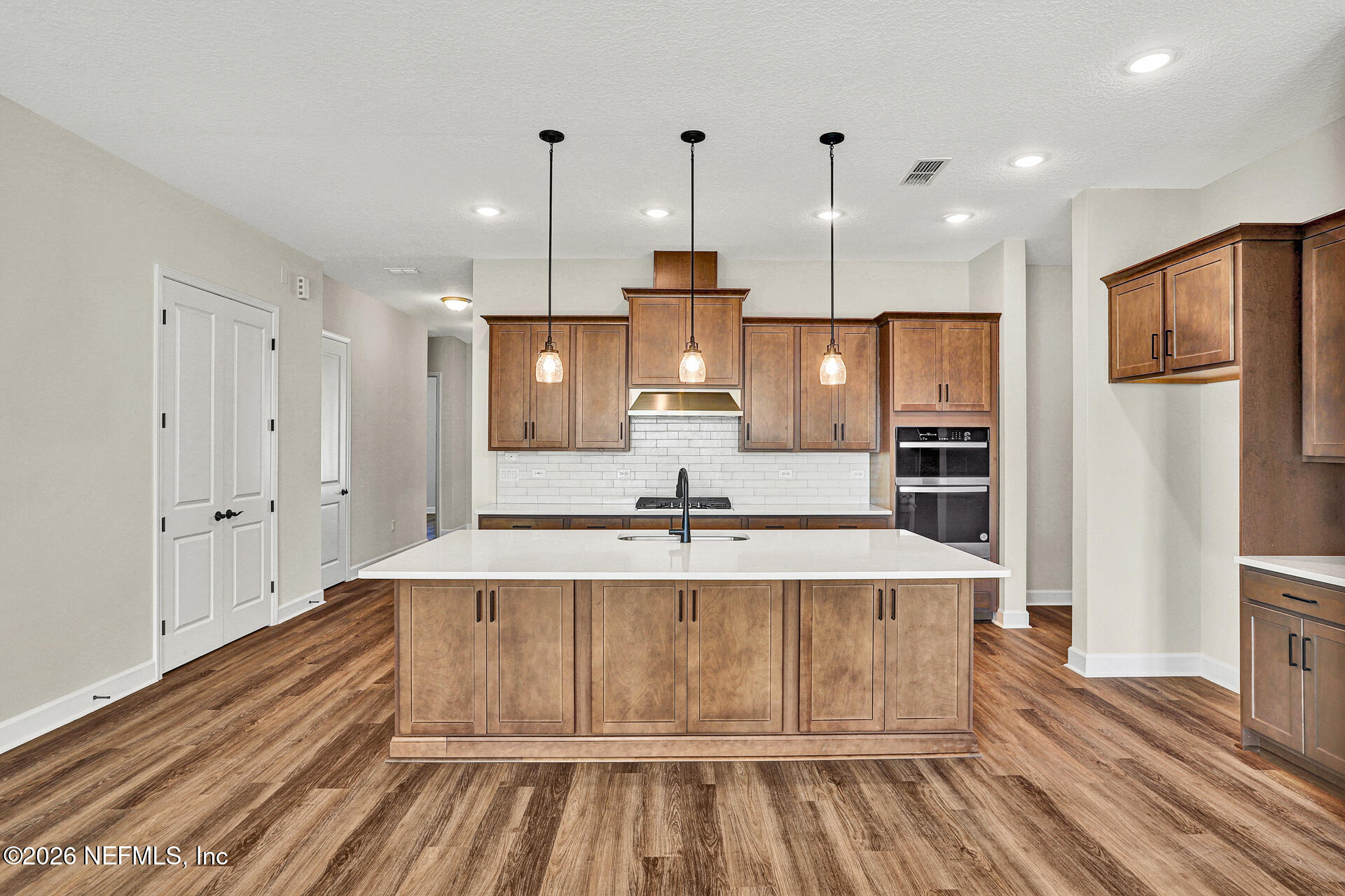 61 Ribera Drive Flagler Beach, FL 32136 - Photo 19 of 21 a large kitchen with stainless steel appliances a large counter top and wooden floors
