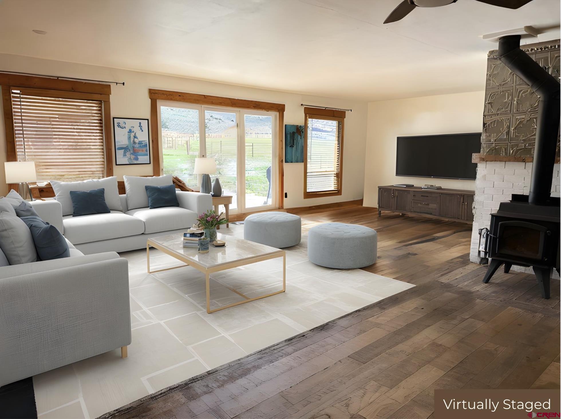 577 Pashuta Drive Gunnison, CO 81230 - Photo 11 of 41 a living room with furniture a flat screen tv and a large window