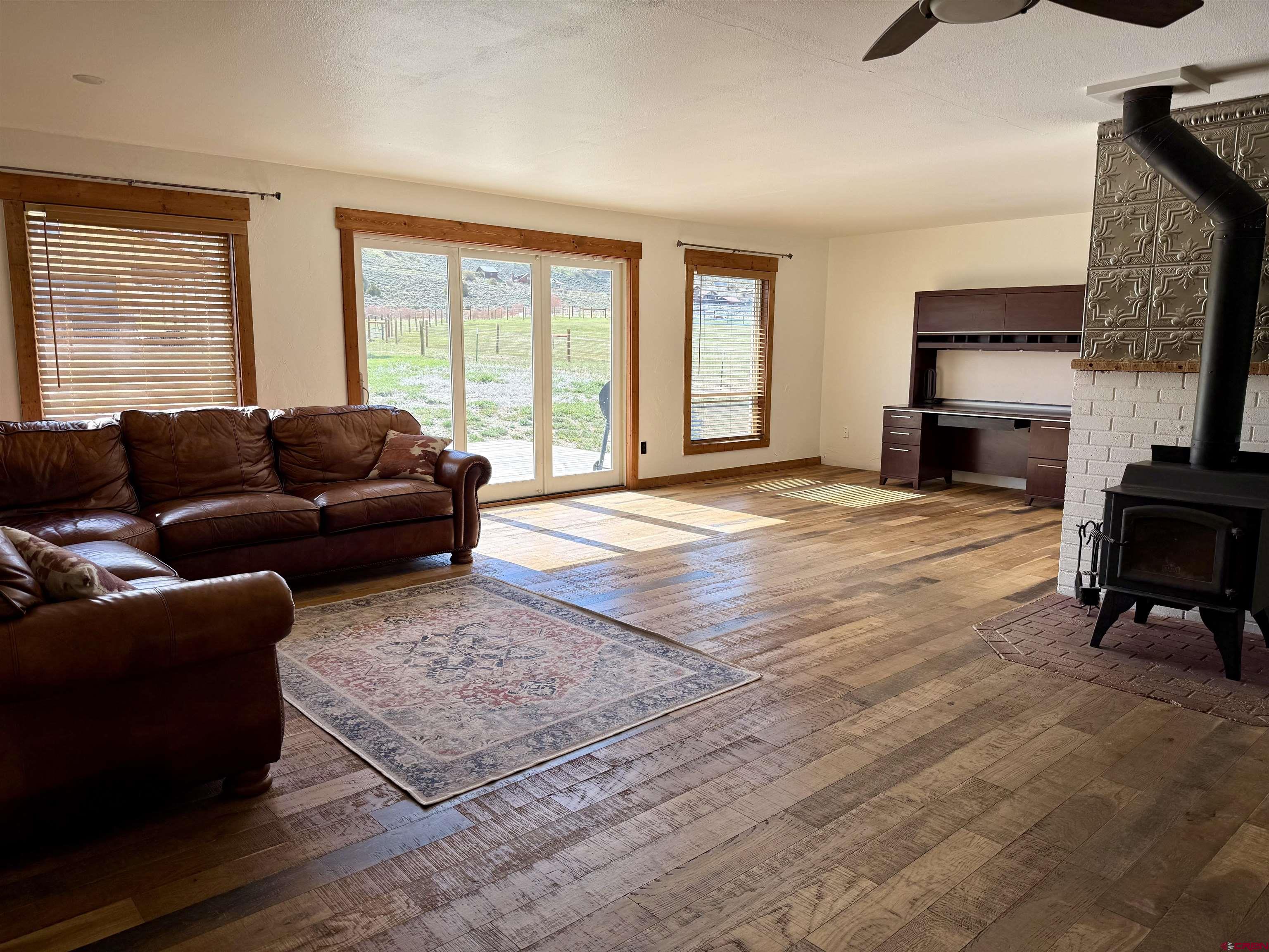 577 Pashuta Drive Gunnison, CO 81230 - Photo 12 of 41 a living room with furniture fireplace and flat screen tv