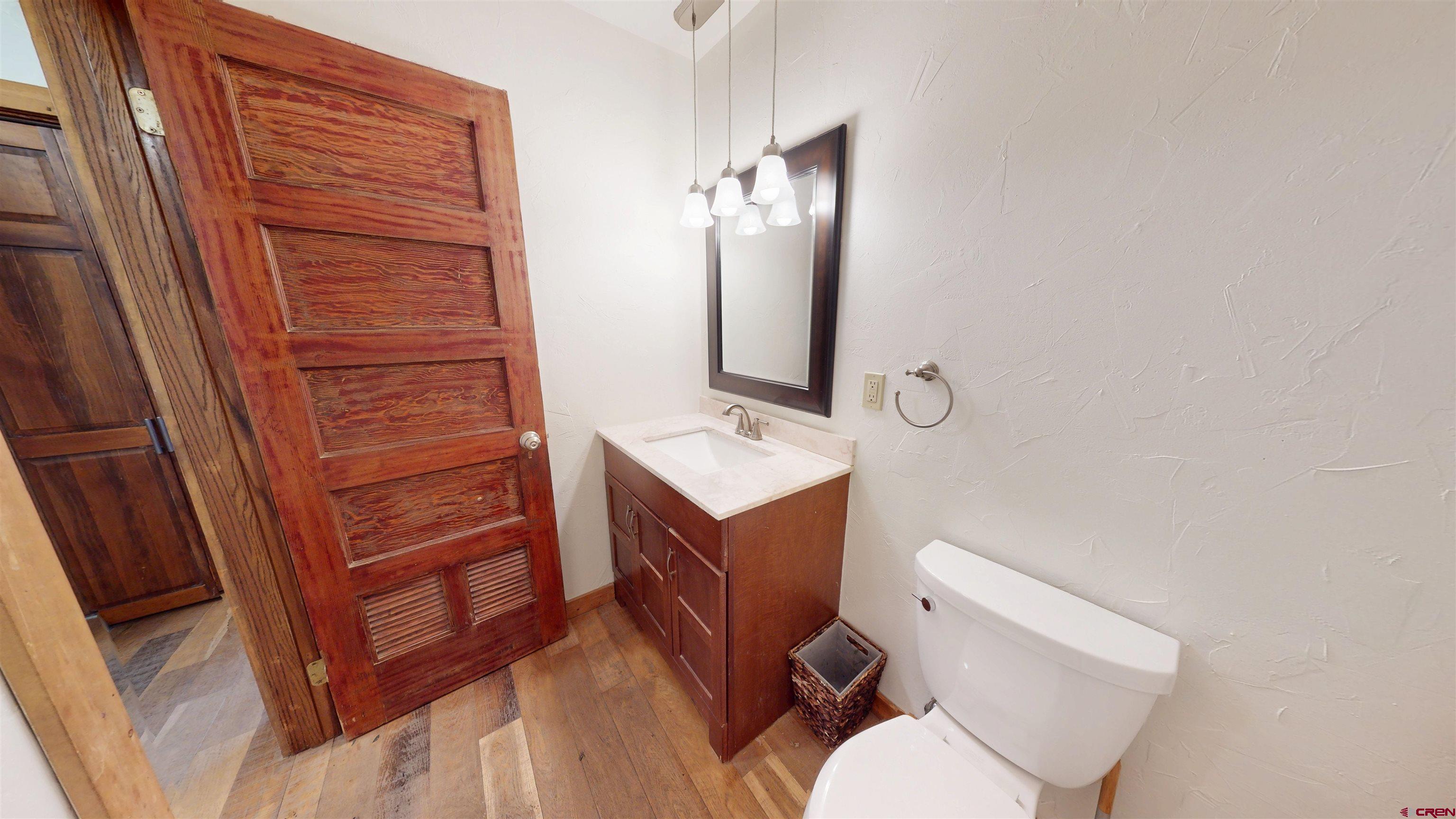 577 Pashuta Drive Gunnison, CO 81230 - Photo 13 of 41 a bathroom with a toilet a sink and mirror