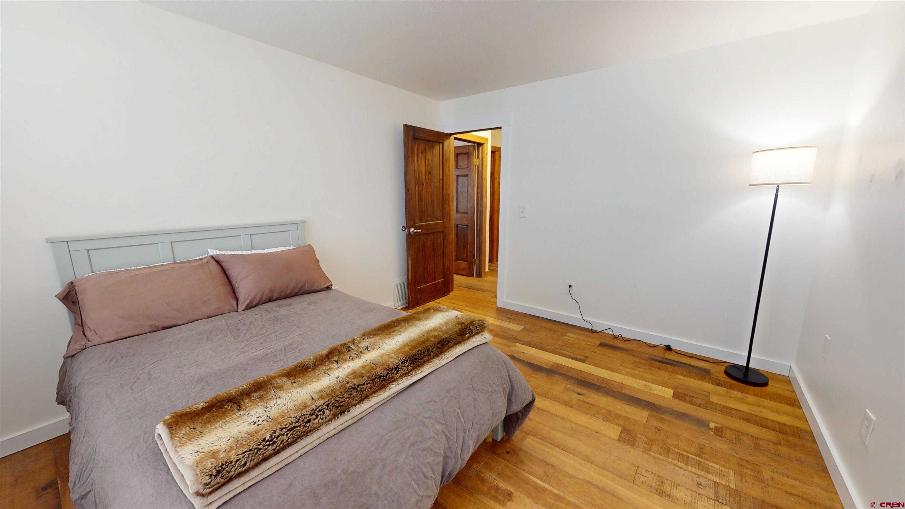 577 Pashuta Drive Gunnison, CO 81230 - Photo 14 of 41 a bedroom with a bed and a night stand