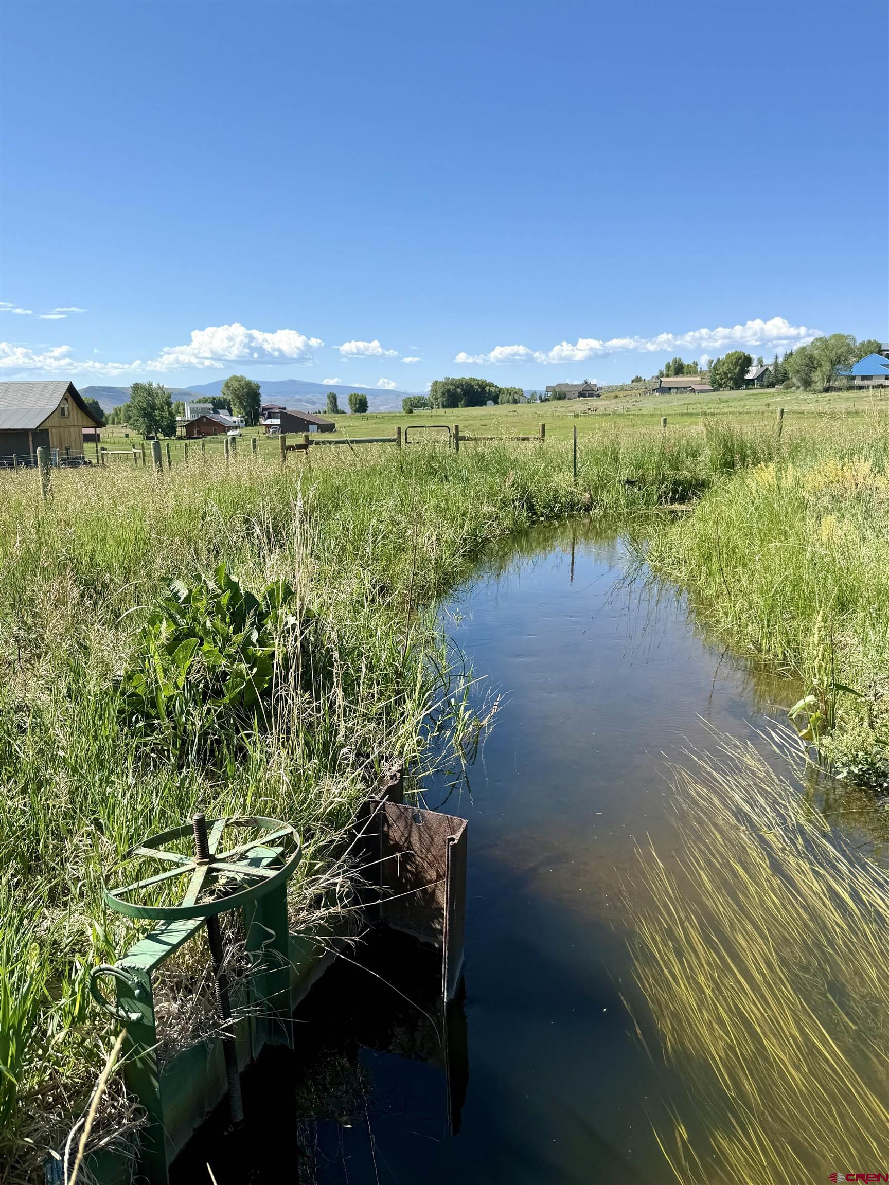 577 Pashuta Drive Gunnison, CO 81230 - Photo 34 of 41 a view of a lake with a yard