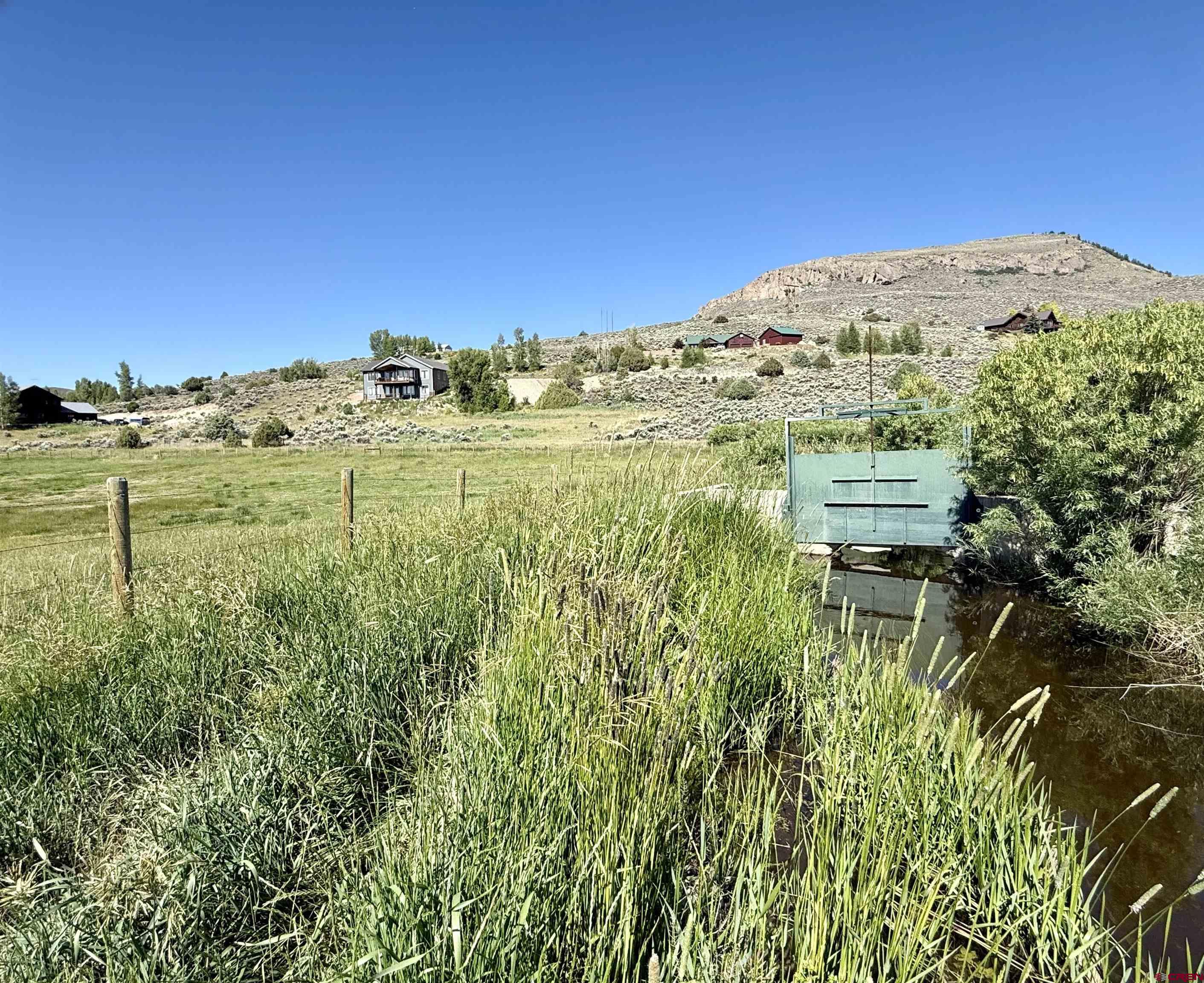 577 Pashuta Drive Gunnison, CO 81230 - Photo 35 of 41 a view of a field with an ocean in the background