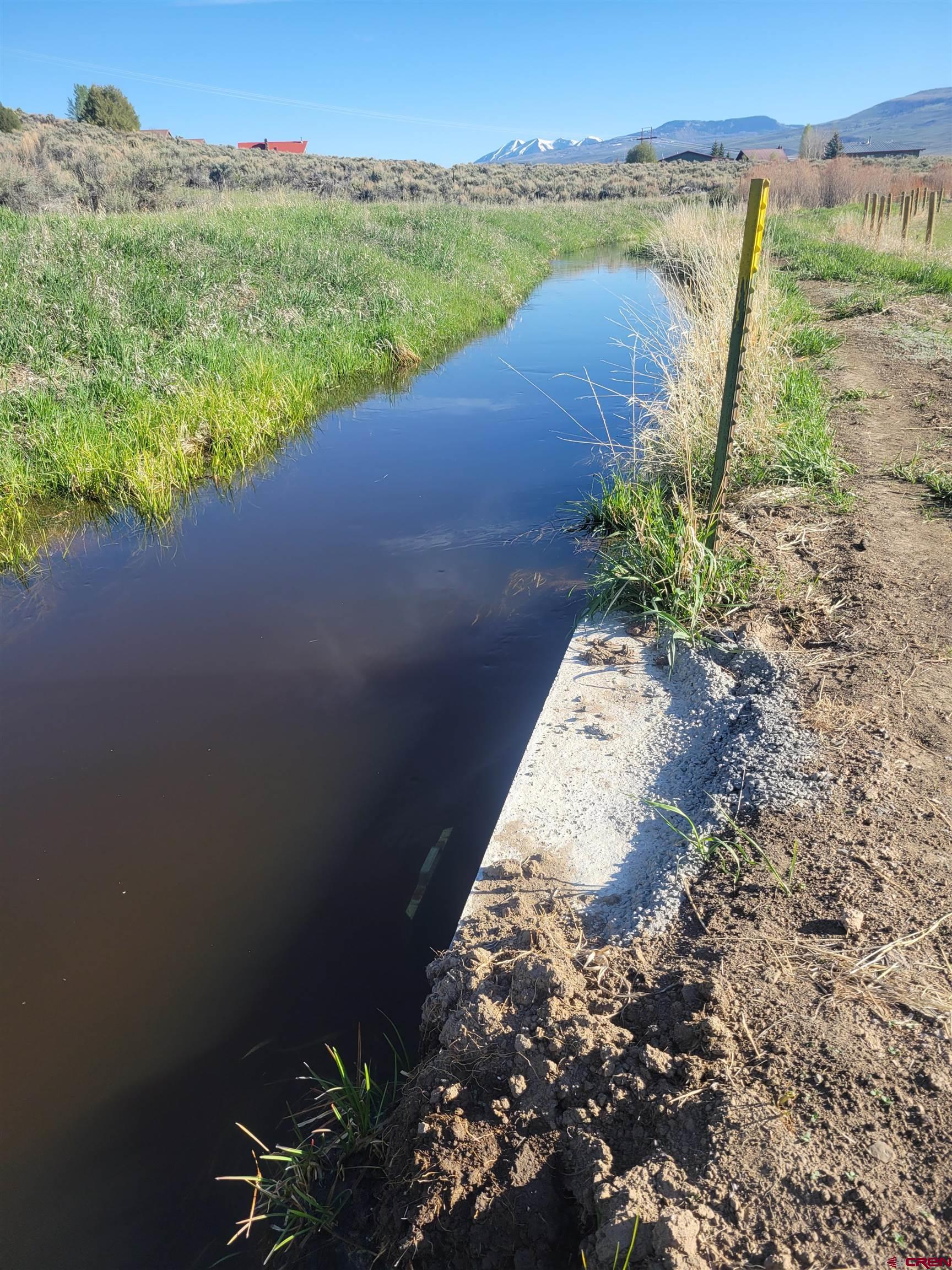 577 Pashuta Drive Gunnison, CO 81230 - Photo 5 of 41 a view of a lake with a yard