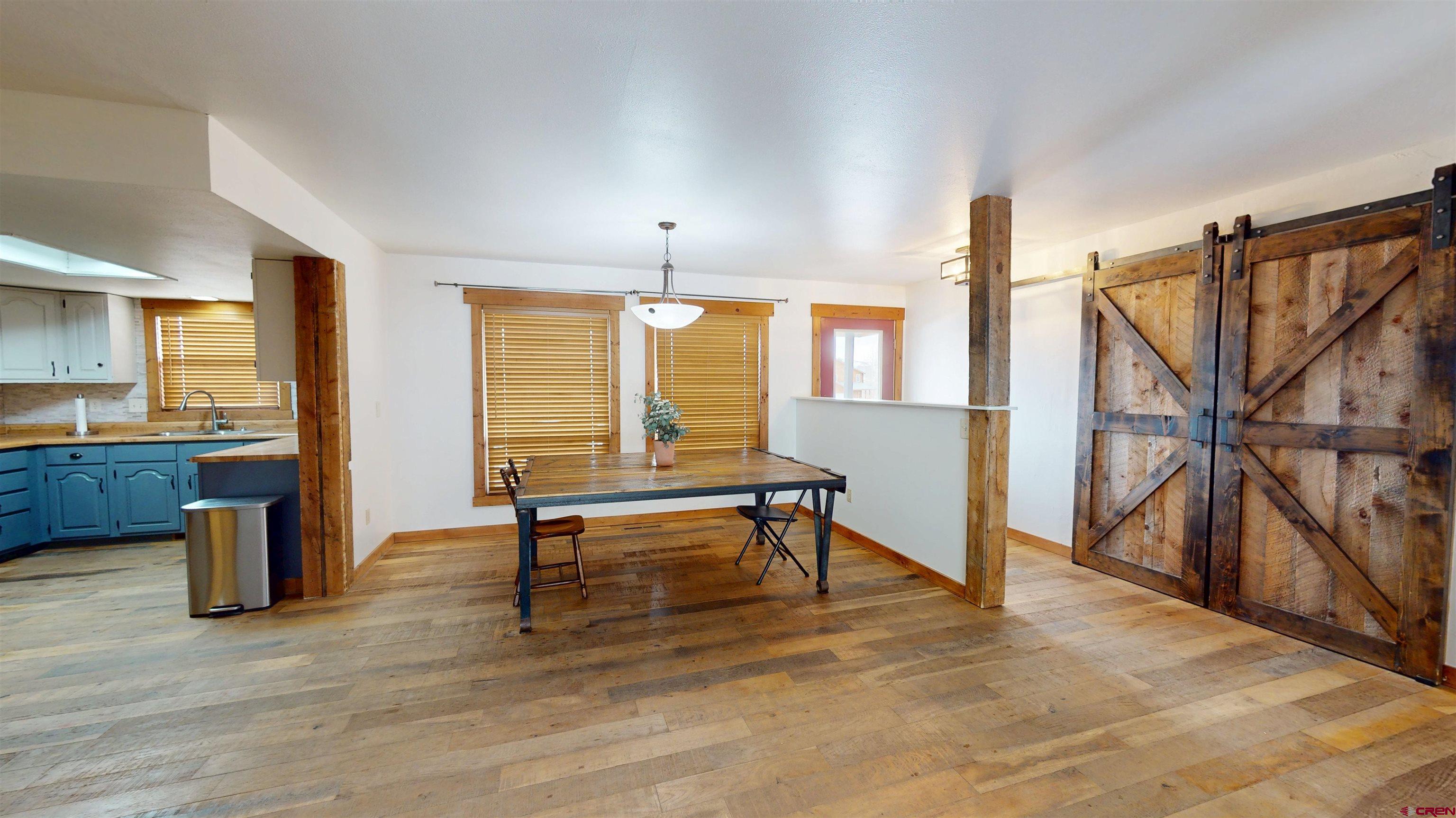 577 Pashuta Drive Gunnison, CO 81230 - Photo 8 of 41 a view of an empty room with wooden floor and furniture