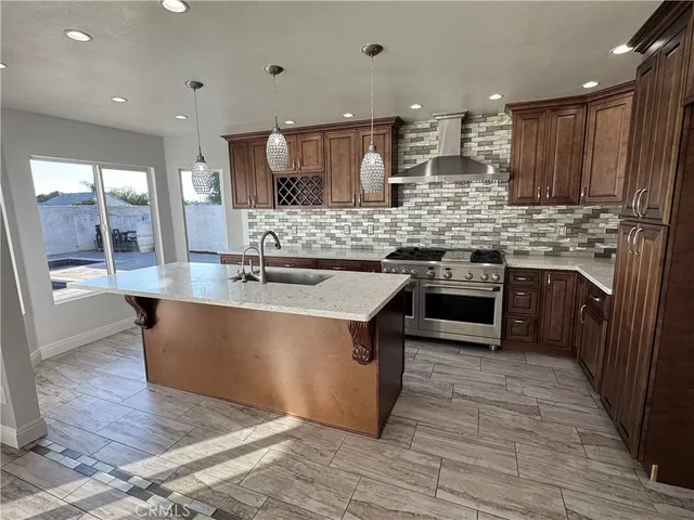 a kitchen with stainless steel appliances granite countertop a stove and a sink