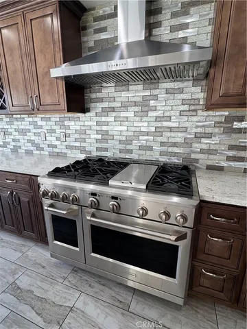 a stove top oven sitting inside of a kitchen