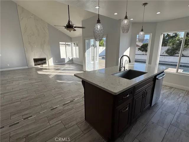 a kitchen with a stove and a wooden floor