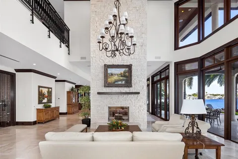 a dining room with furniture and large windows