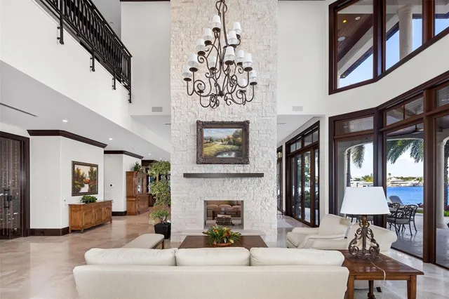 a dining room with furniture and large windows