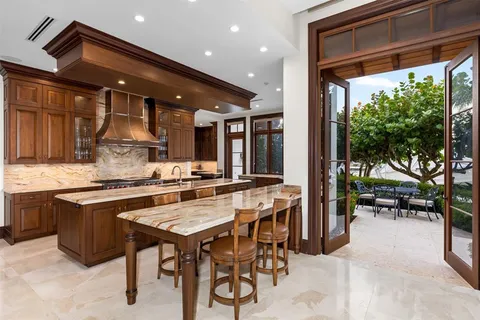 a kitchen with granite countertop white cabinets and sink