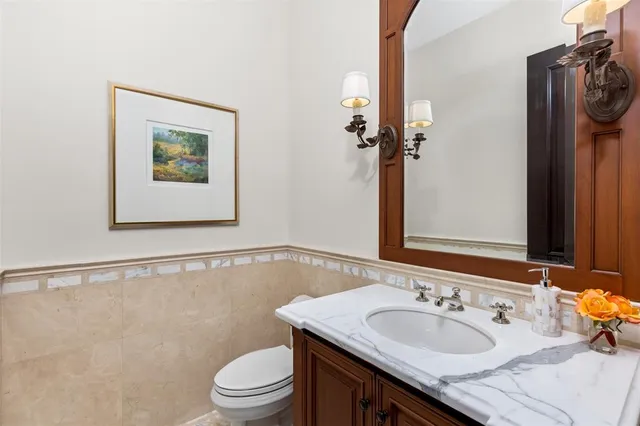 a living room with a large bed and a chandelier