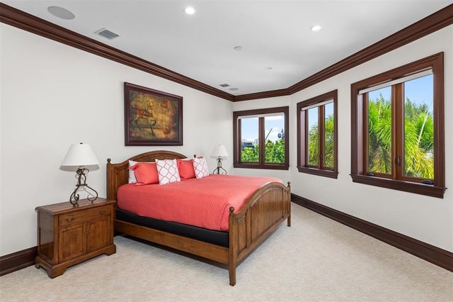 a front view of multi story residential apartment building with yard and green space