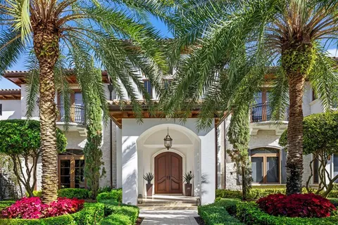 a living room with furniture a fireplace and a chandelier