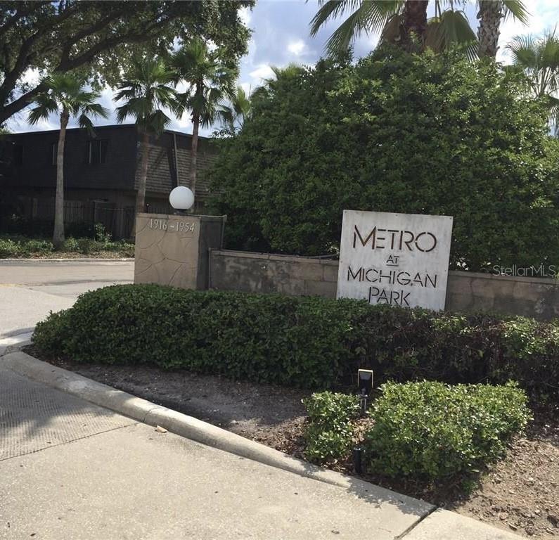 1928 South Conway Road, Unit 28 Orlando, FL 32812 - Photo 1 of 1 a sign that is sitting in front of flowers