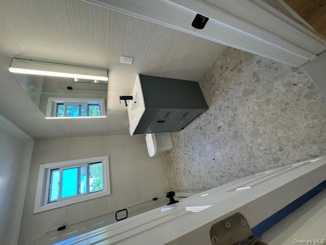 12 Backman Avenue, Unit 1 Ellenville, NY 12428 - Photo 9 of 9 a bathroom with a sink a toilet and mirror