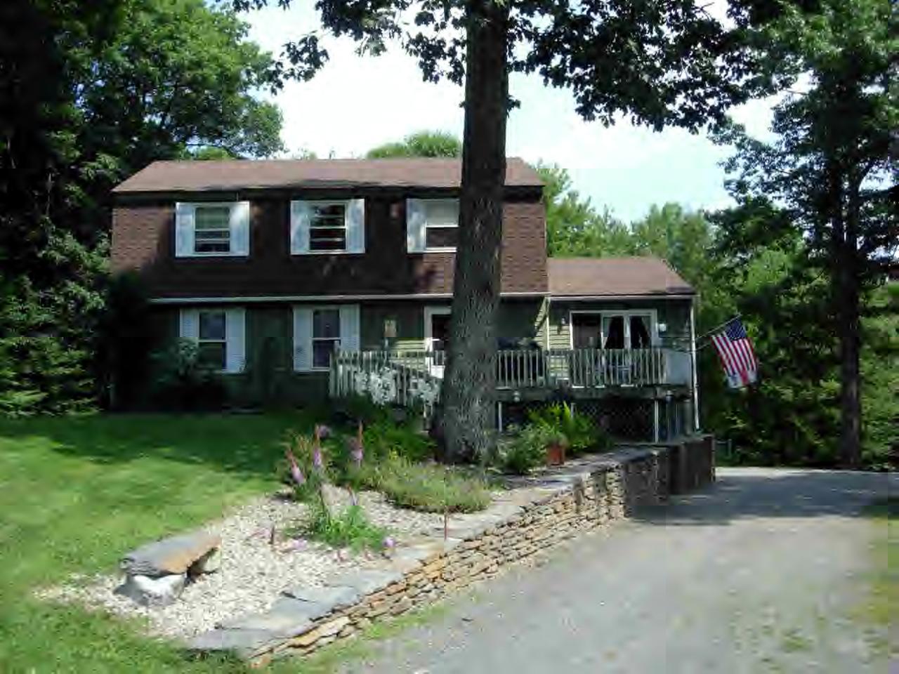259 NW Road Westhampton, MA 01027 - Photo 1 of 10 a front view of a house with a garden and trees