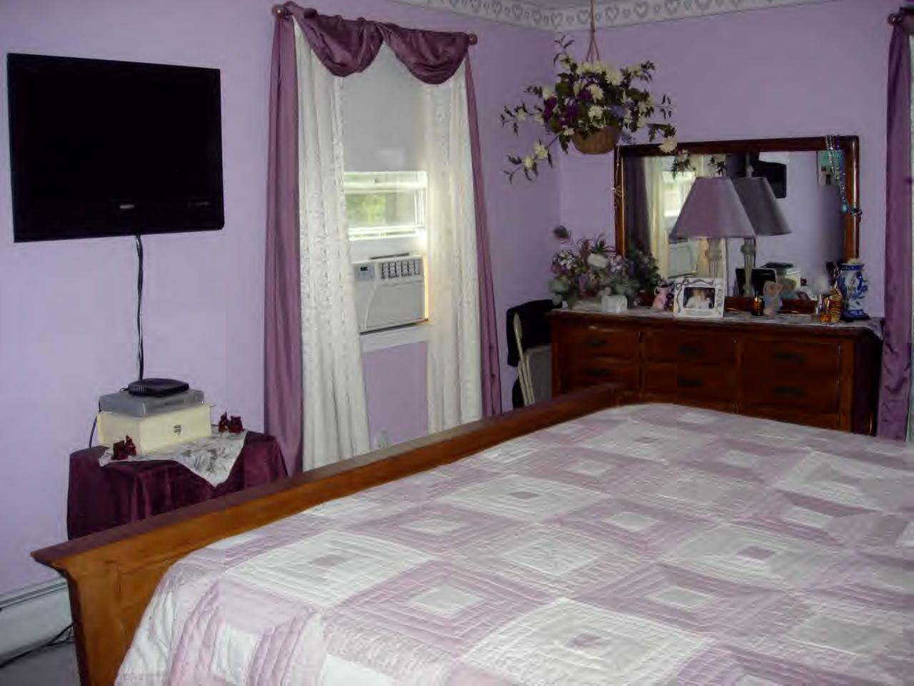 259 NW Road Westhampton, MA 01027 - Photo 6 of 10 a bedroom with a bed and a flat tv screen on dresser