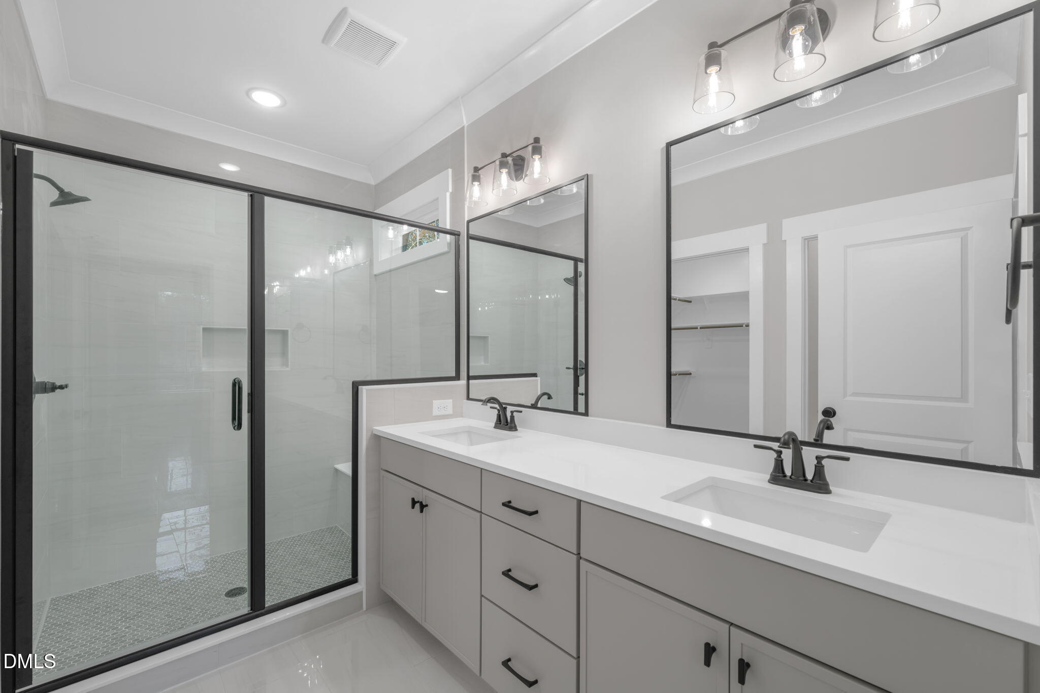 45 Beauview Way Zebulon, NC 27597 - Photo 18 of 40 a bathroom with a double vanity sink a mirror and a shower
