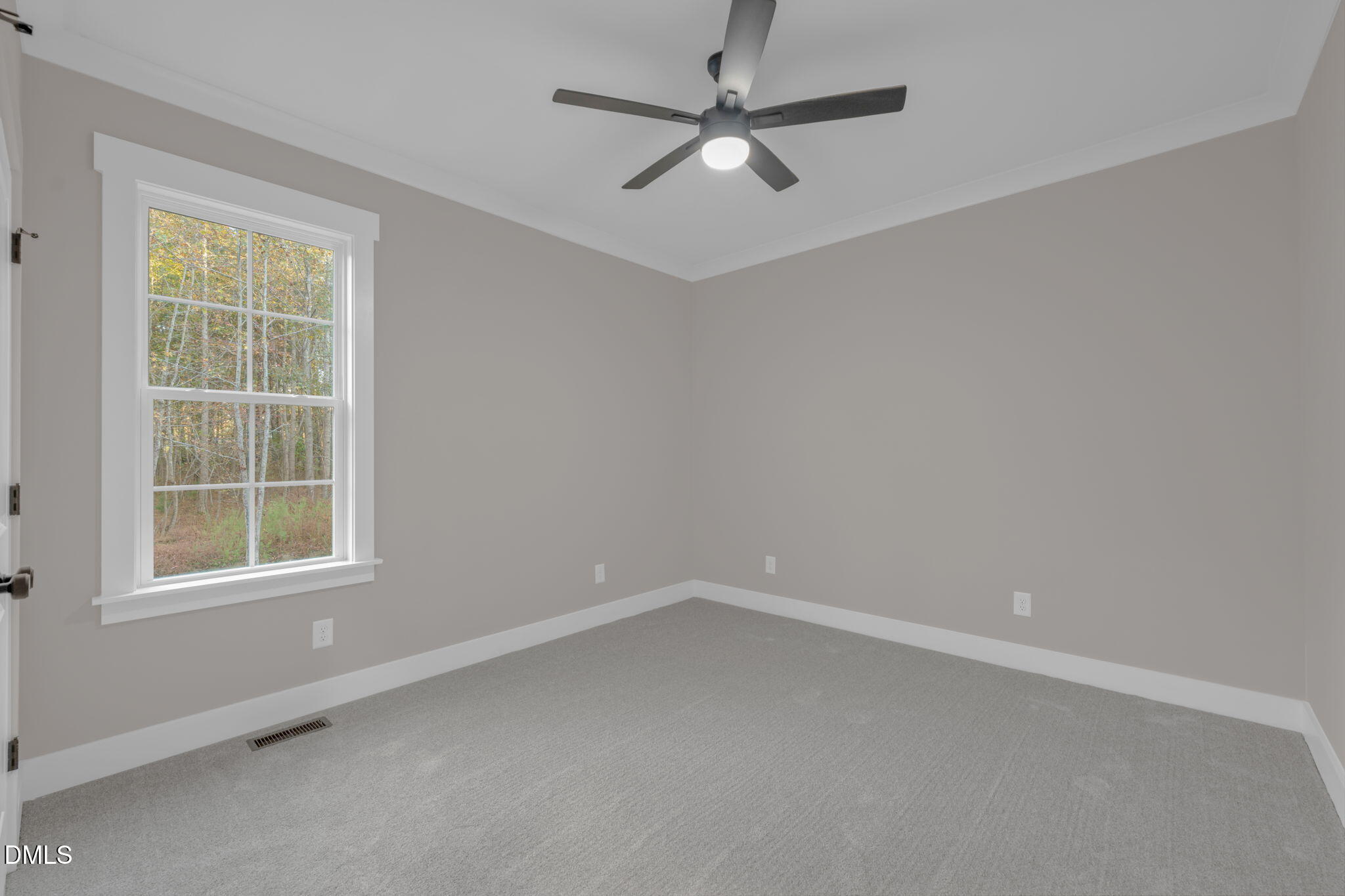 45 Beauview Way Zebulon, NC 27597 - Photo 21 of 40 an empty room with a window and a fan