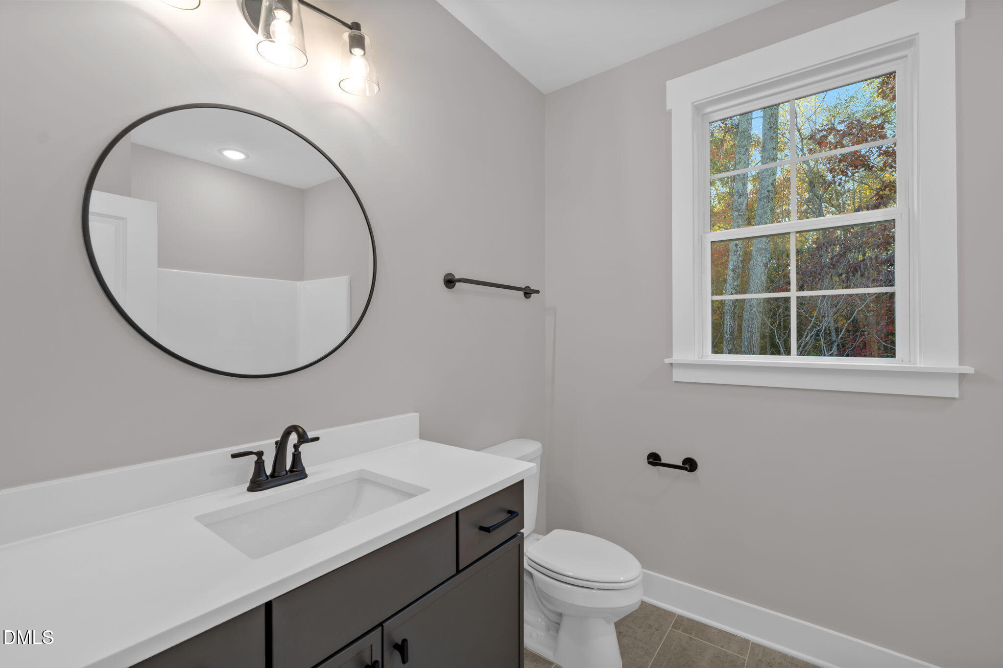 45 Beauview Way Zebulon, NC 27597 - Photo 32 of 40 a bathroom with a sink a toilet and a mirror