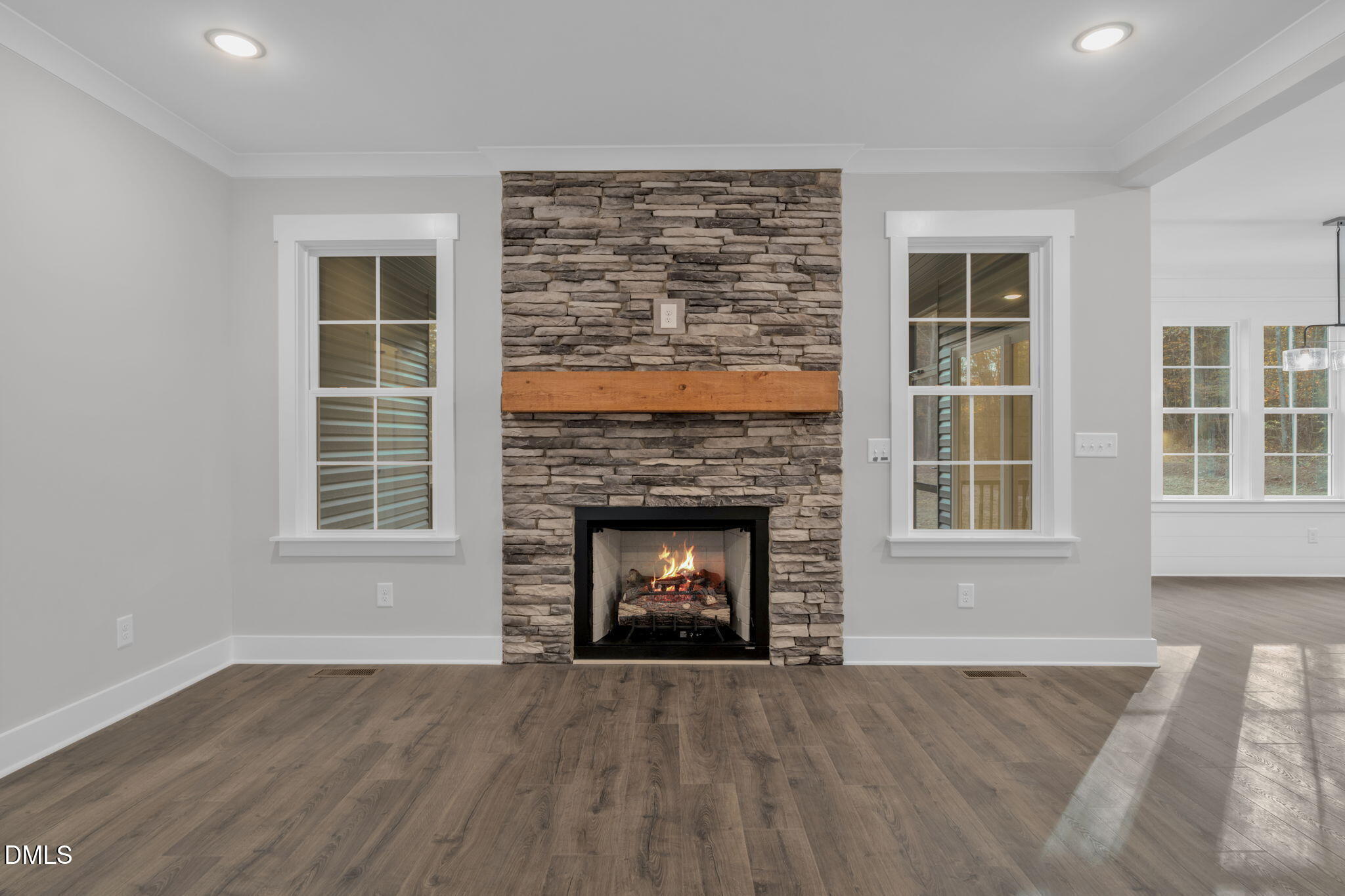 45 Beauview Way Zebulon, NC 27597 - Photo 4 of 40 a view of an empty room with wooden floor fireplace and a window