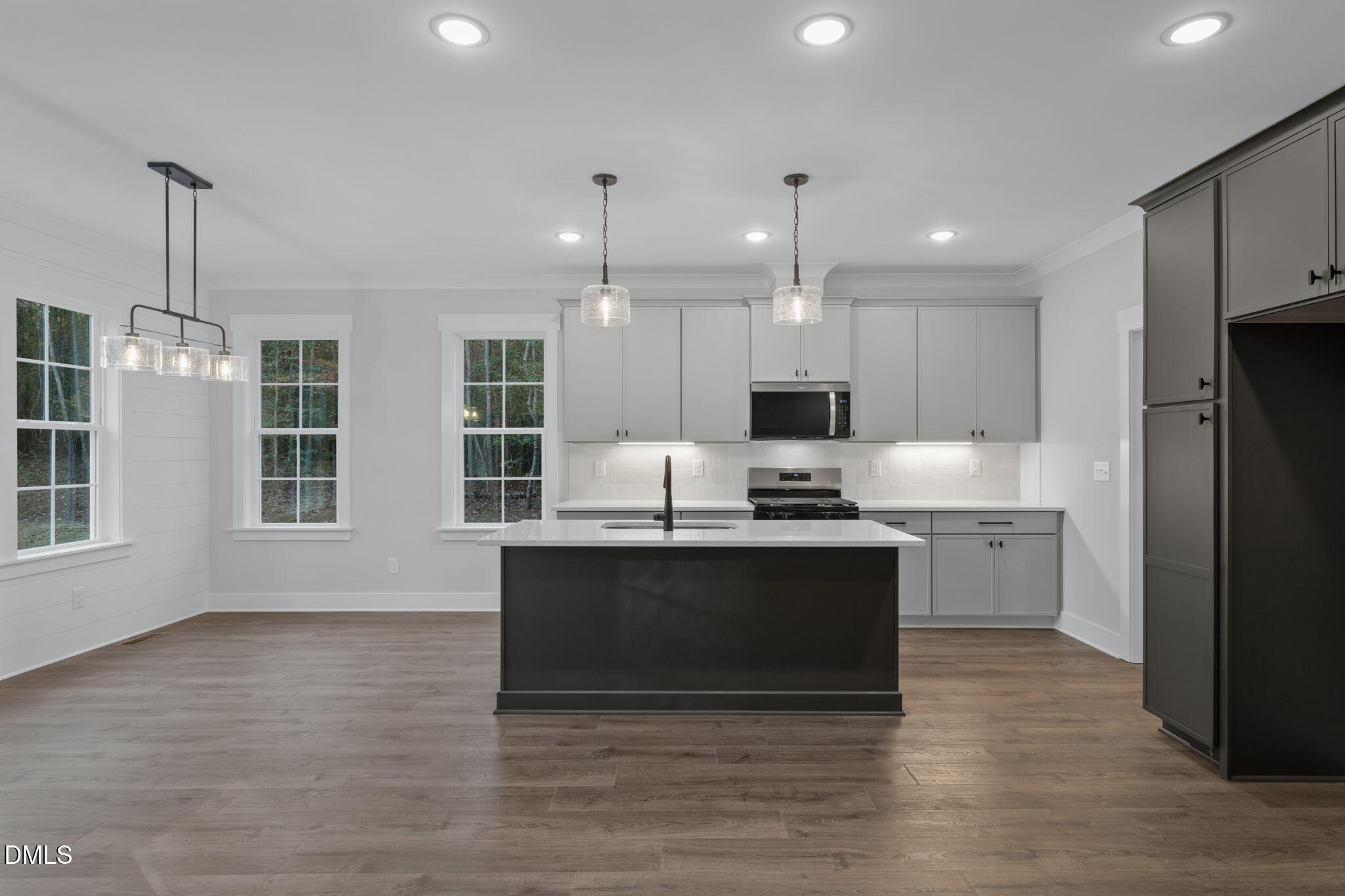 45 Beauview Way Zebulon, NC 27597 - Photo 7 of 40 a large kitchen with granite countertop a stove top oven a sink dishwasher a refrigerator and white cabinets with wooden floor
