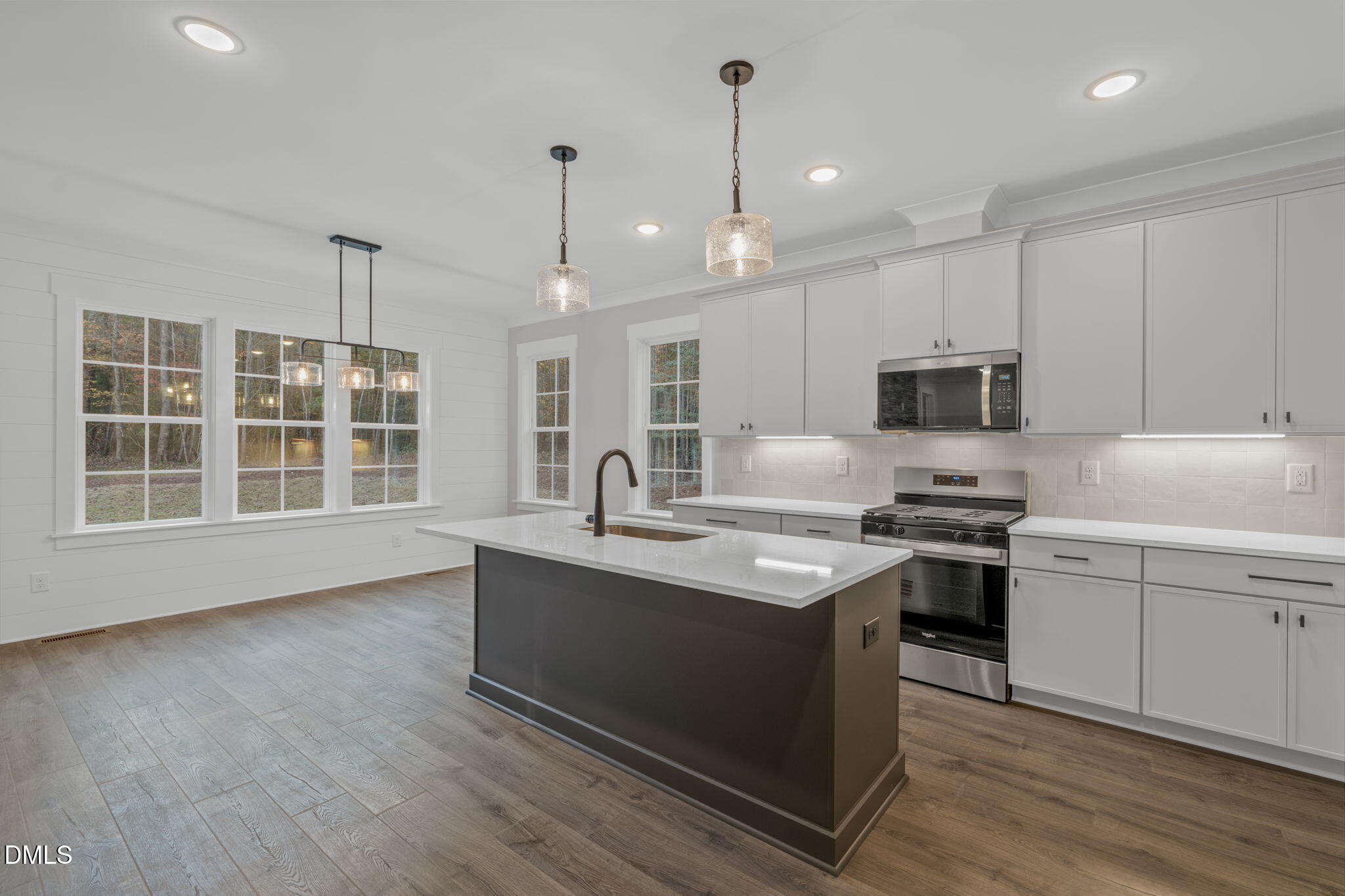 45 Beauview Way Zebulon, NC 27597 - Photo 9 of 40 a kitchen with stainless steel appliances granite countertop a sink a stove and a wooden floors