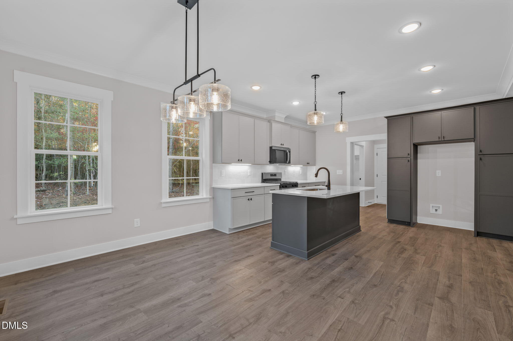 45 Beauview Way Zebulon, NC 27597 - Photo 10 of 40 a large kitchen with kitchen island a large counter top space a sink stainless steel appliances and cabinets