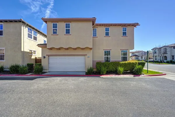 a view of house with outdoor space and parking