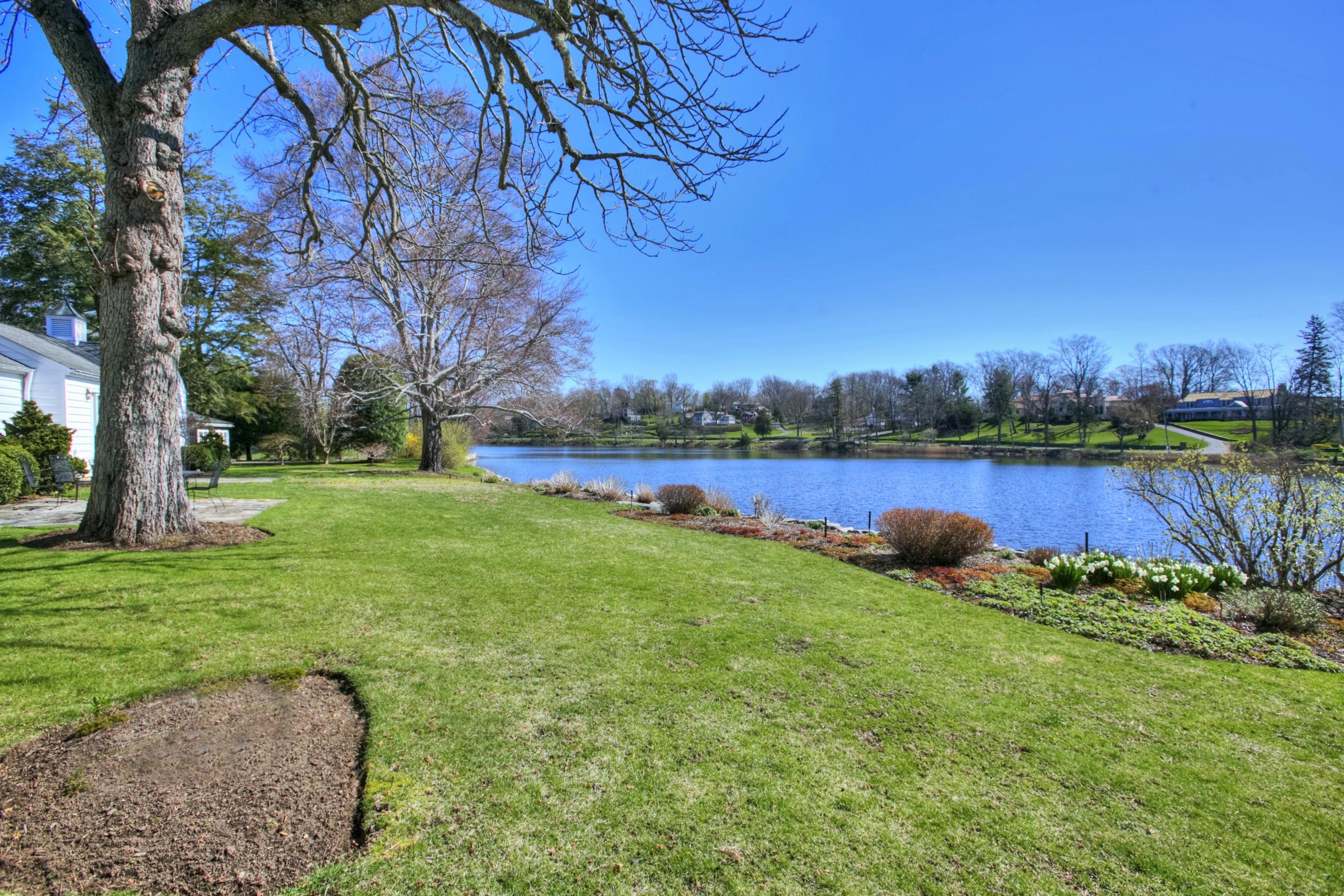 85 Rings End Road Darien, CT 06820 - Photo 4 of 39 a view of a lake with a big yard